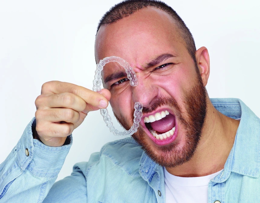 Adult professional smiling while wearing Invisalign aligners Adult professional smiling while wearing Invisalign aligners