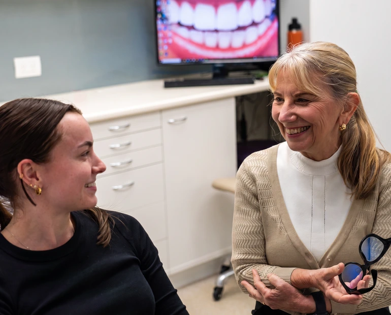 An orthodontist and dentist collaborating on patient care