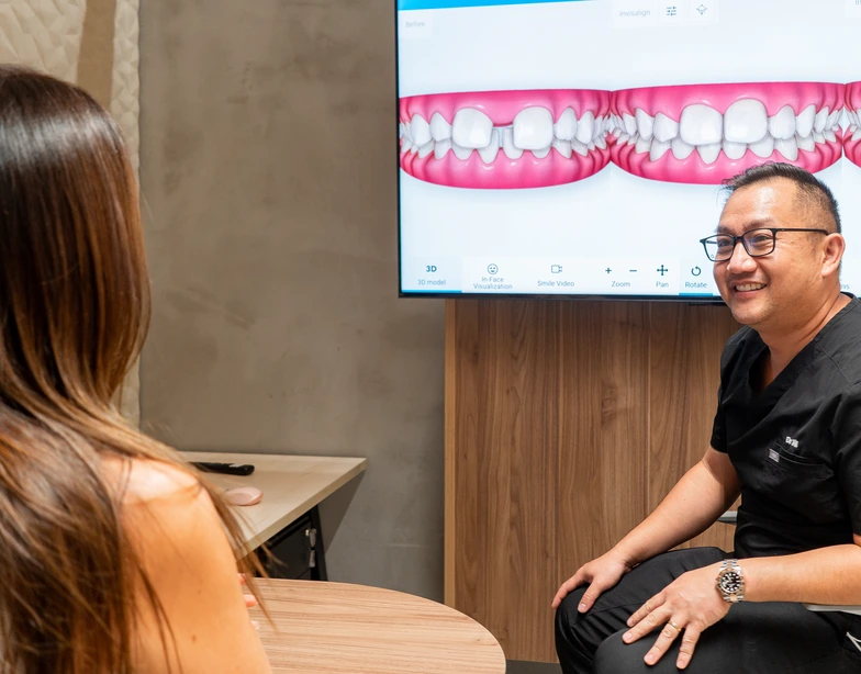 Specialist Orthodontist discussing a treatment plan with a patient Specialist Orthodontist discussing a treatment plan with a patient