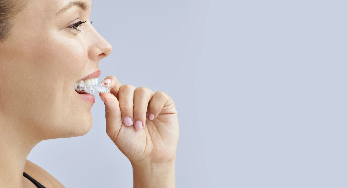 Specialist Orthodontist reviewing an adult's Invisalign progress Specialist Orthodontist reviewing an adult's Invisalign progress